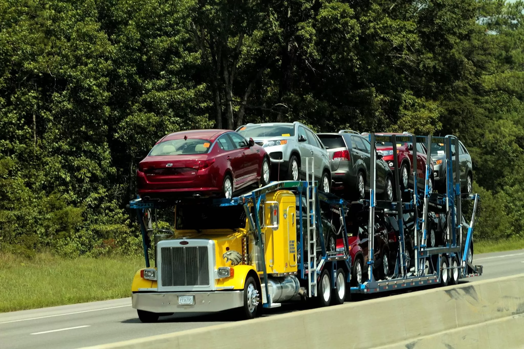Yellow Car hauler loaded with cars