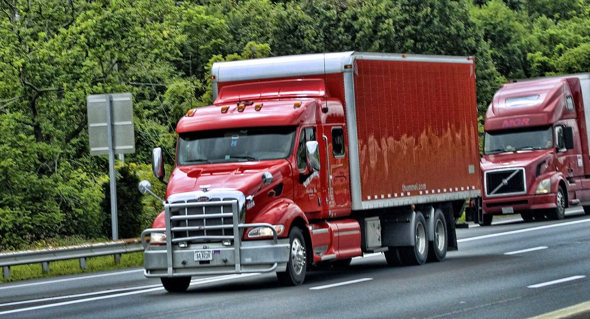 Red Peterbilt and Volvo trucks