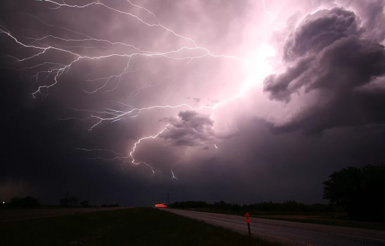 Storm with rain and lightning on the road