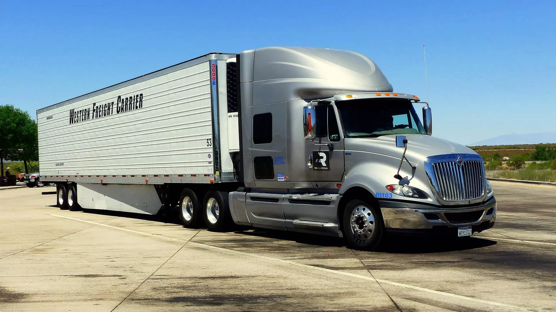 Silver truck with white trailer