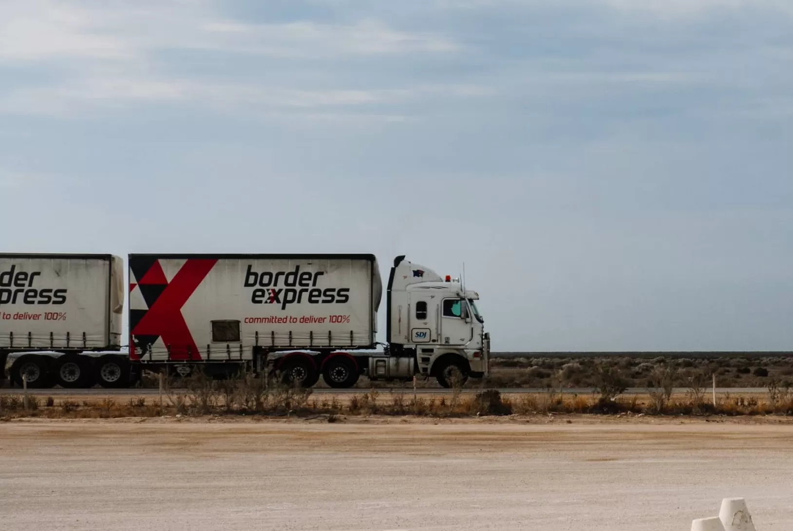 White truck with two trailers