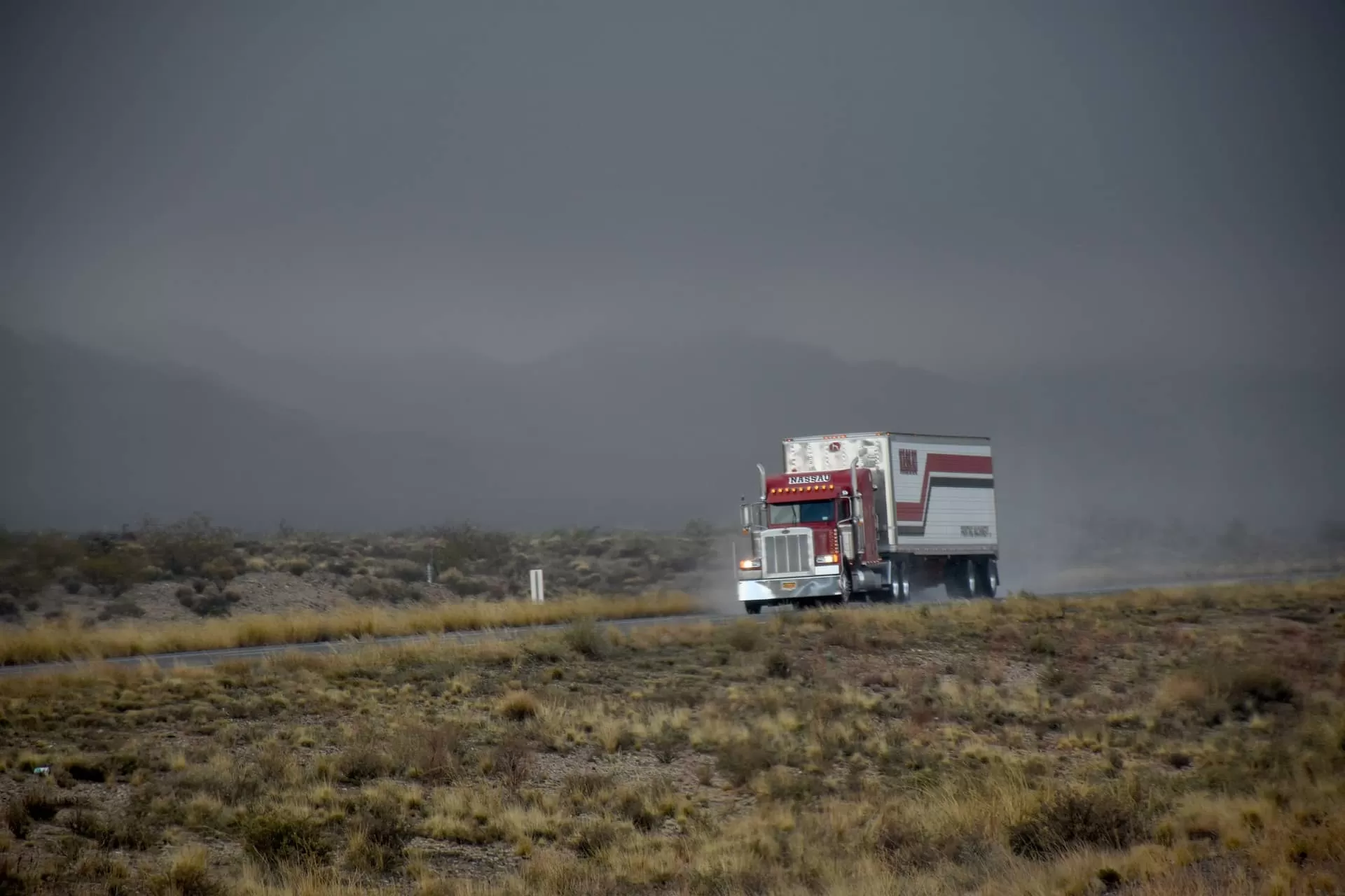 Red truck with trailer on the road