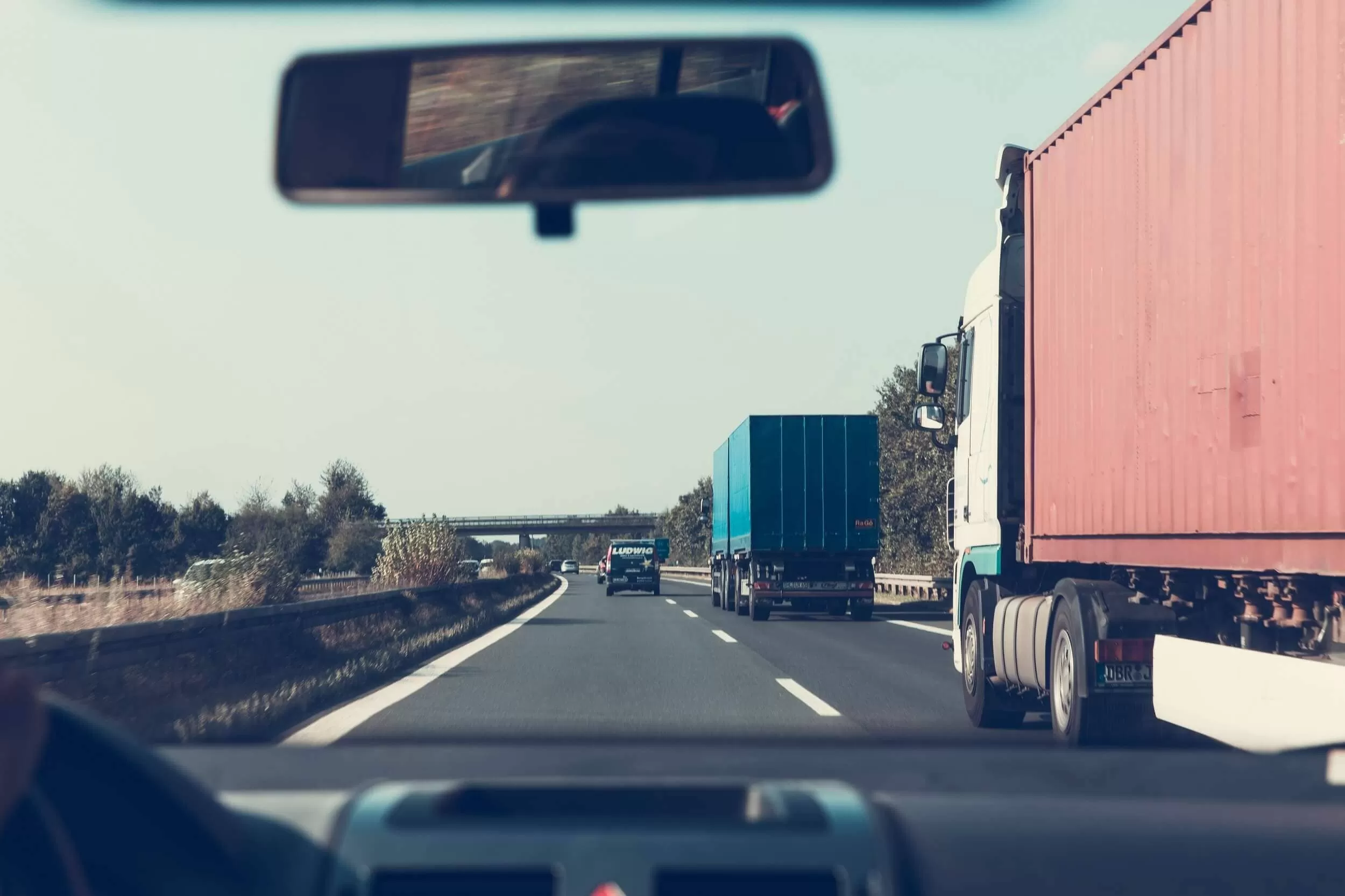 Car on the road with trucks