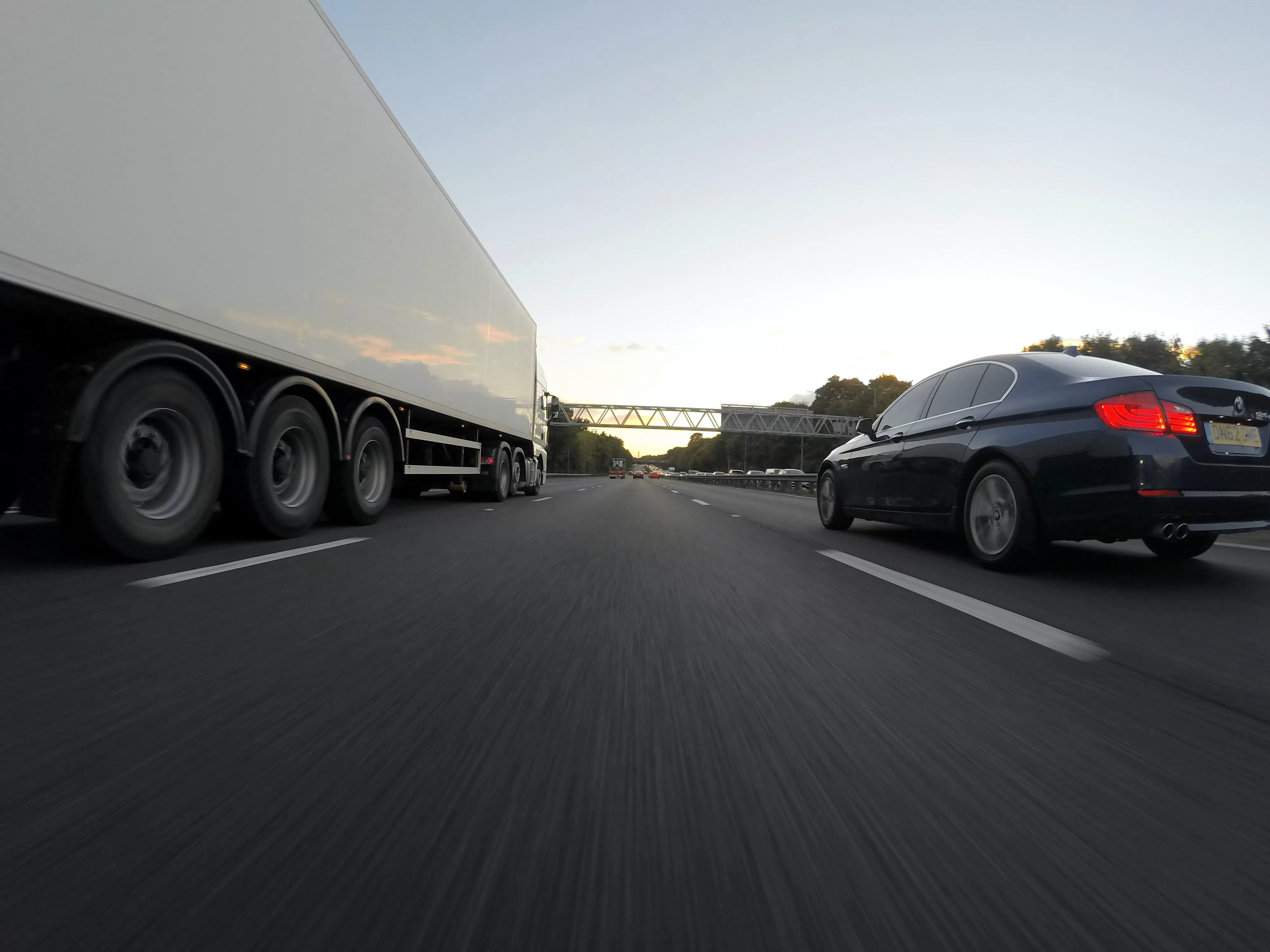 Photo of road with truck and car