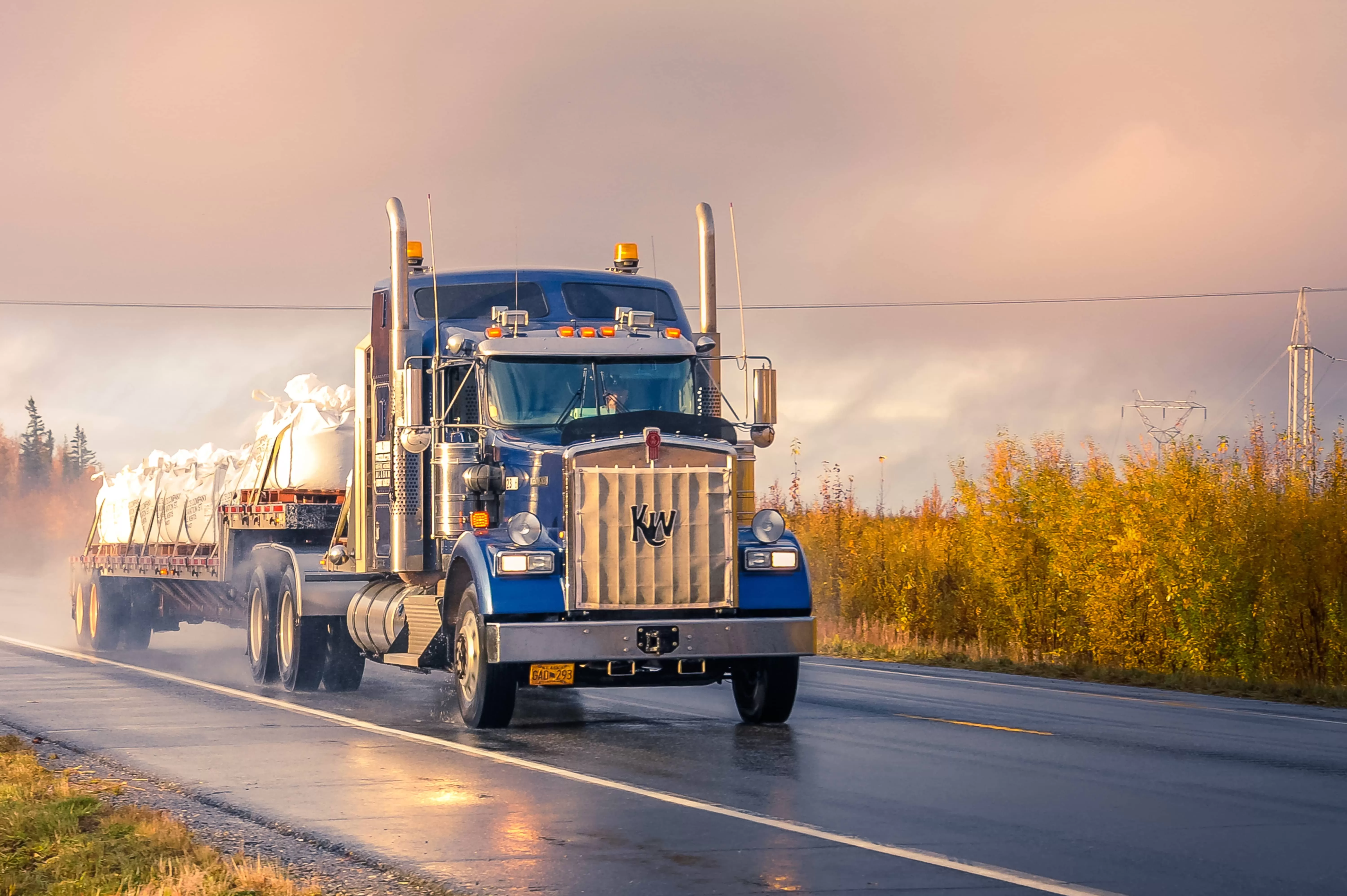 After rain blue Kenworth truck on the road 