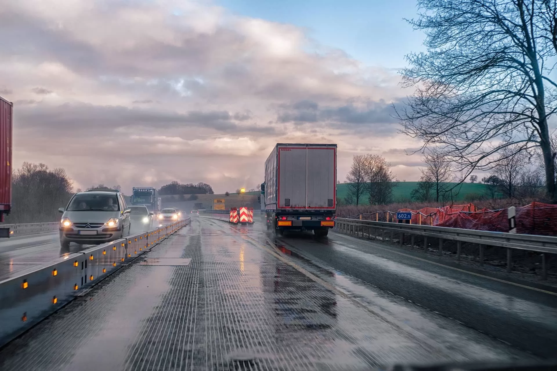 Rain on the road with trucks and cars