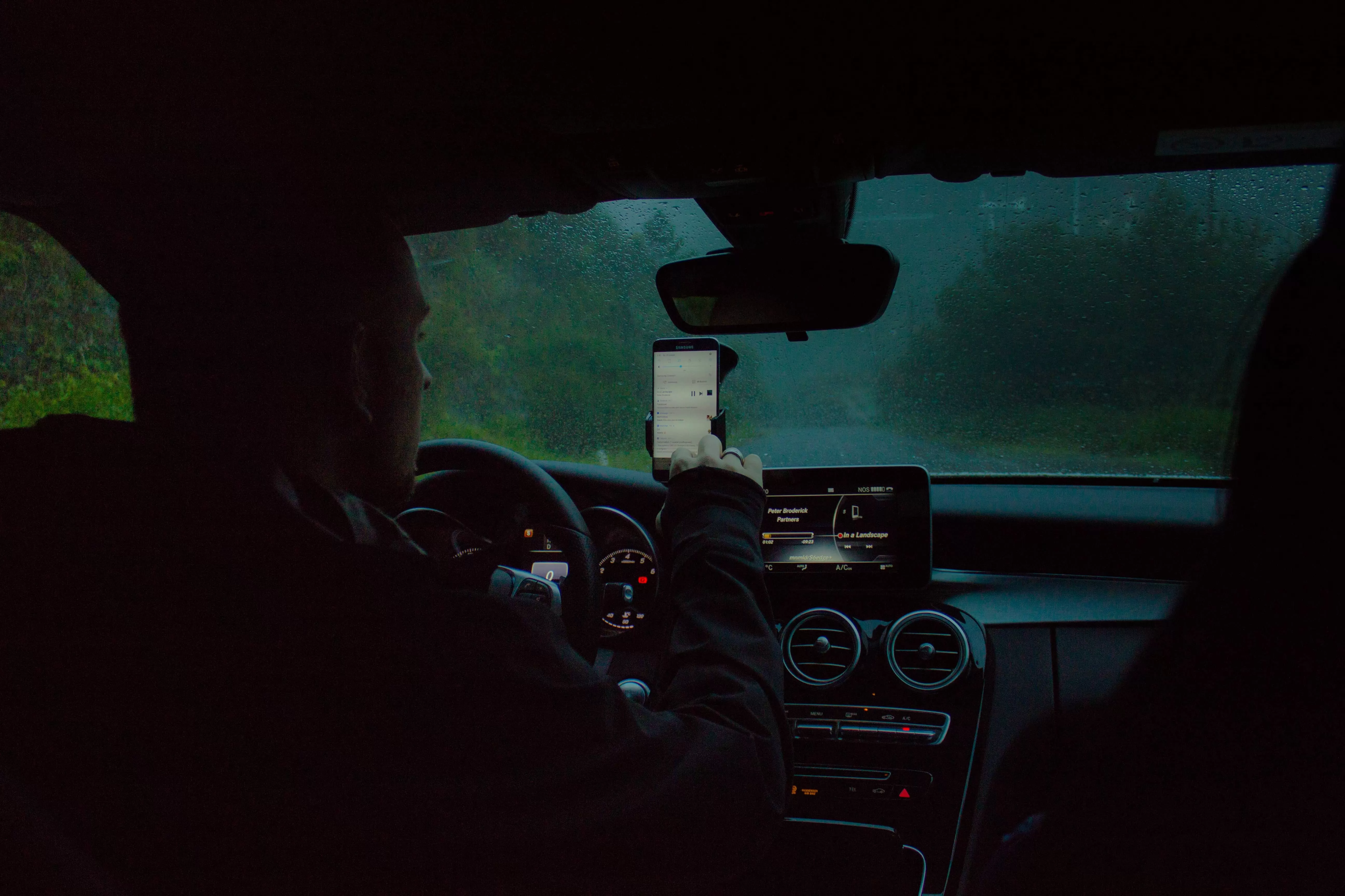 Man inside pickup clicking in smartphone