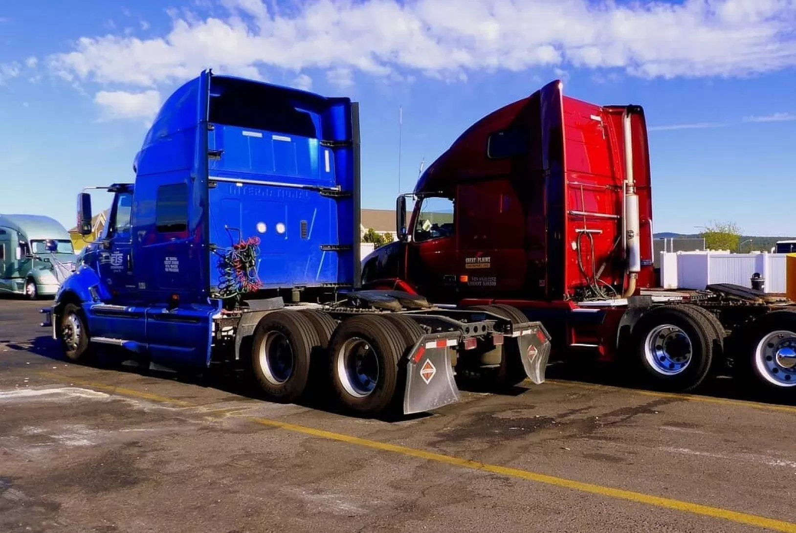 blue and red trucks without trailers