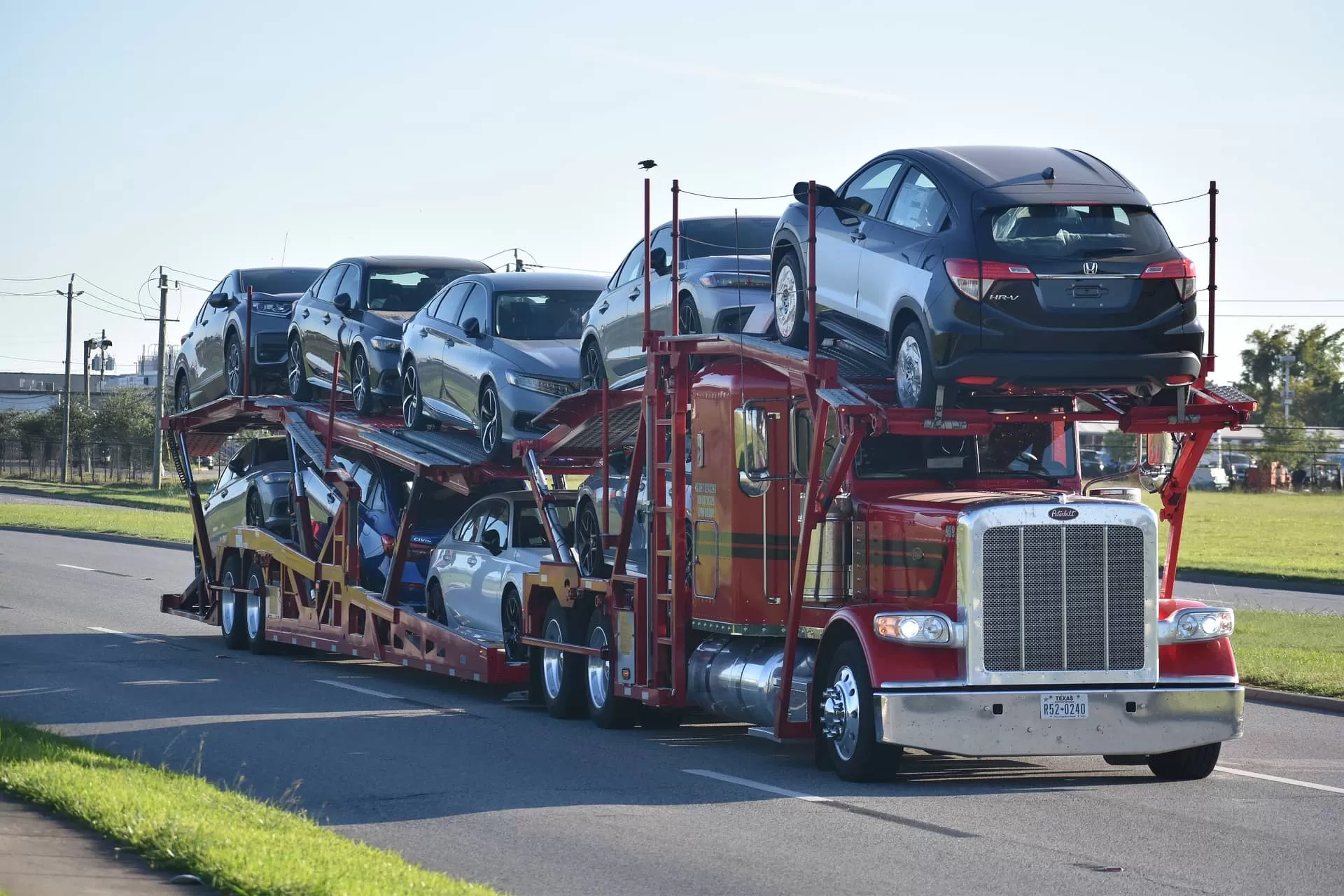 photo of truck hauler with cars