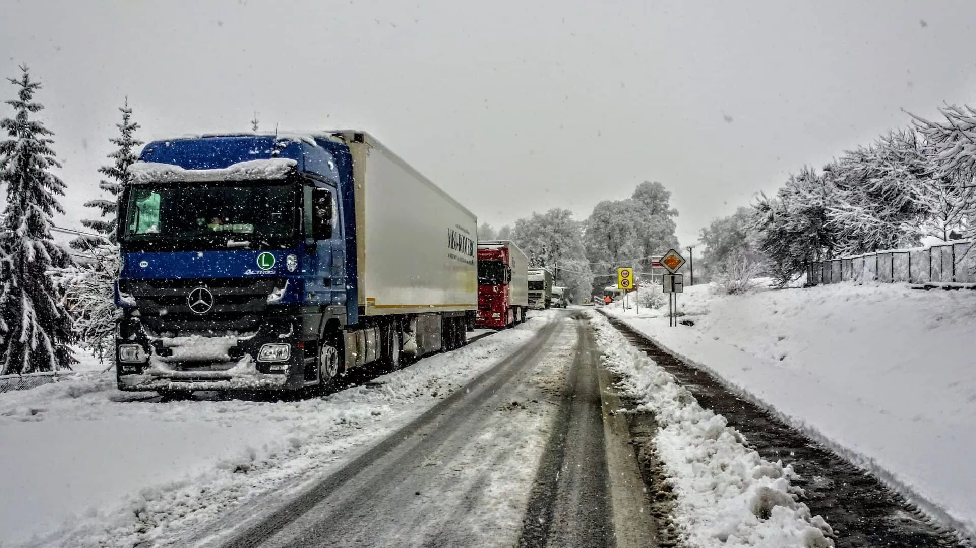 snowy road with trucks